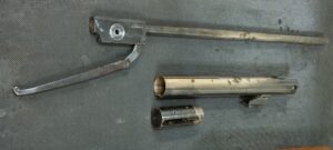 Metalwork with paint removed and corrosion evident